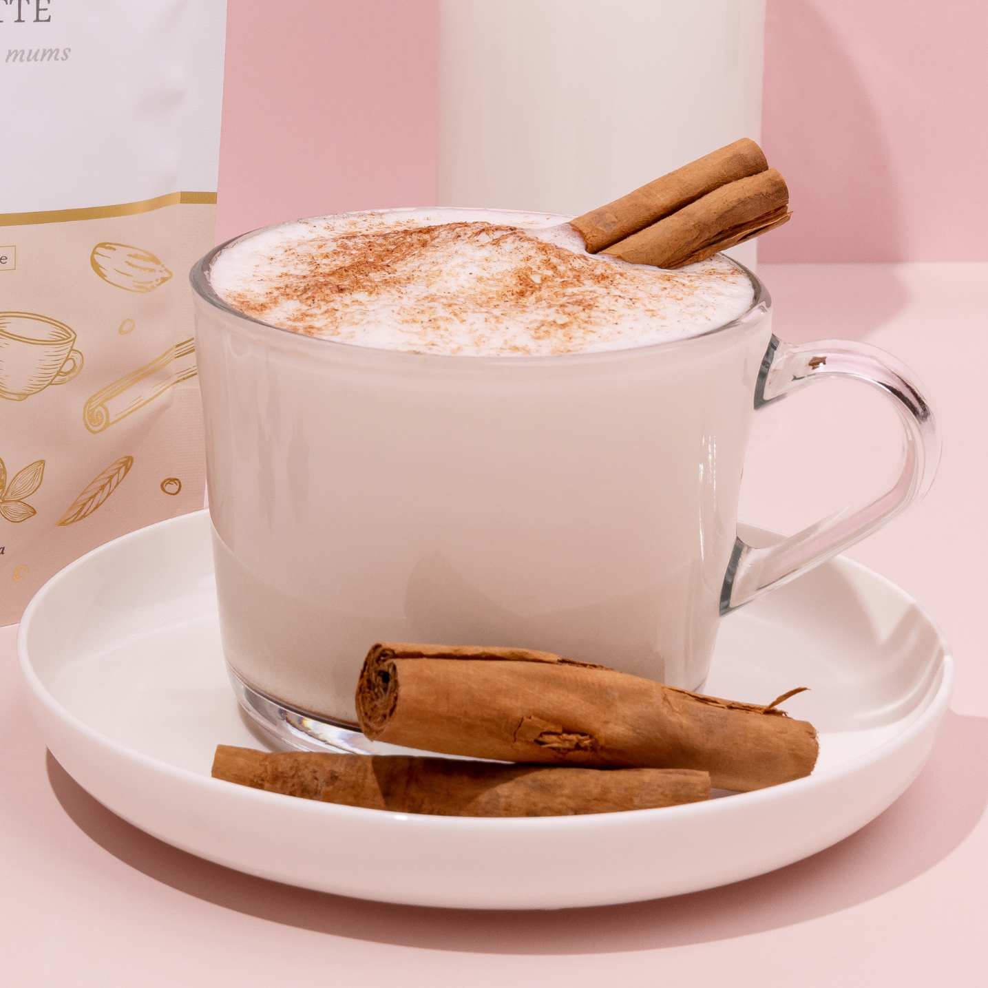 Made to Milk creamy chai latte package with a cup of latte on a pink background