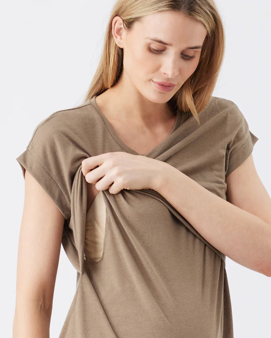 Pregnant woman wearing a brown nursing top on a white background