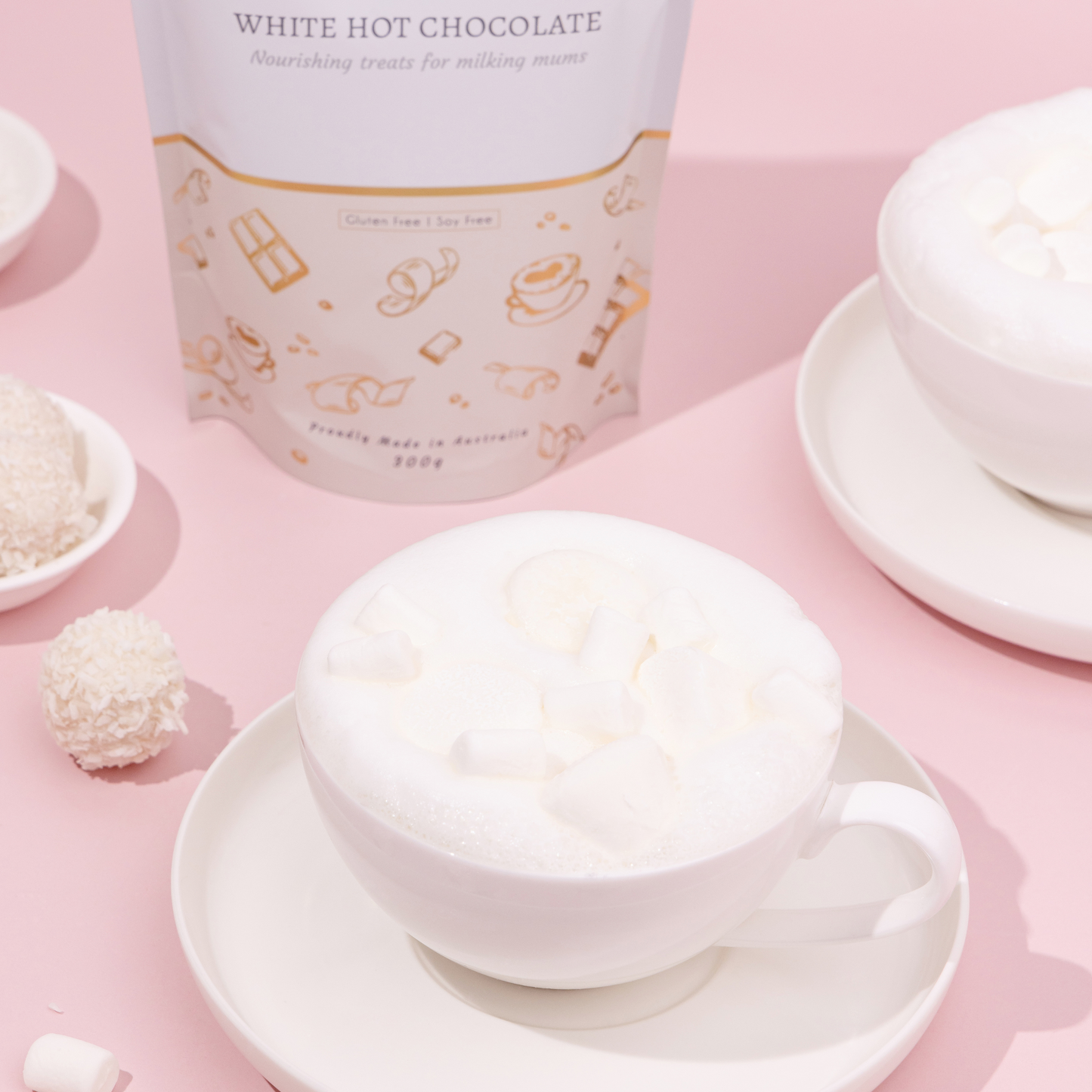 White hot chocolate with a container labeled 'White Hot Chocolate' on a pink background