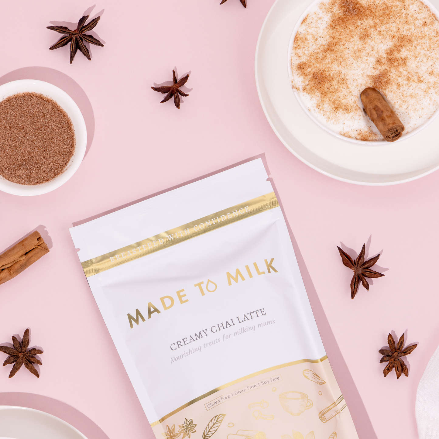 Product packaging for 'Made to Milk' creamy chai latte on a pink background with spices and a latte.