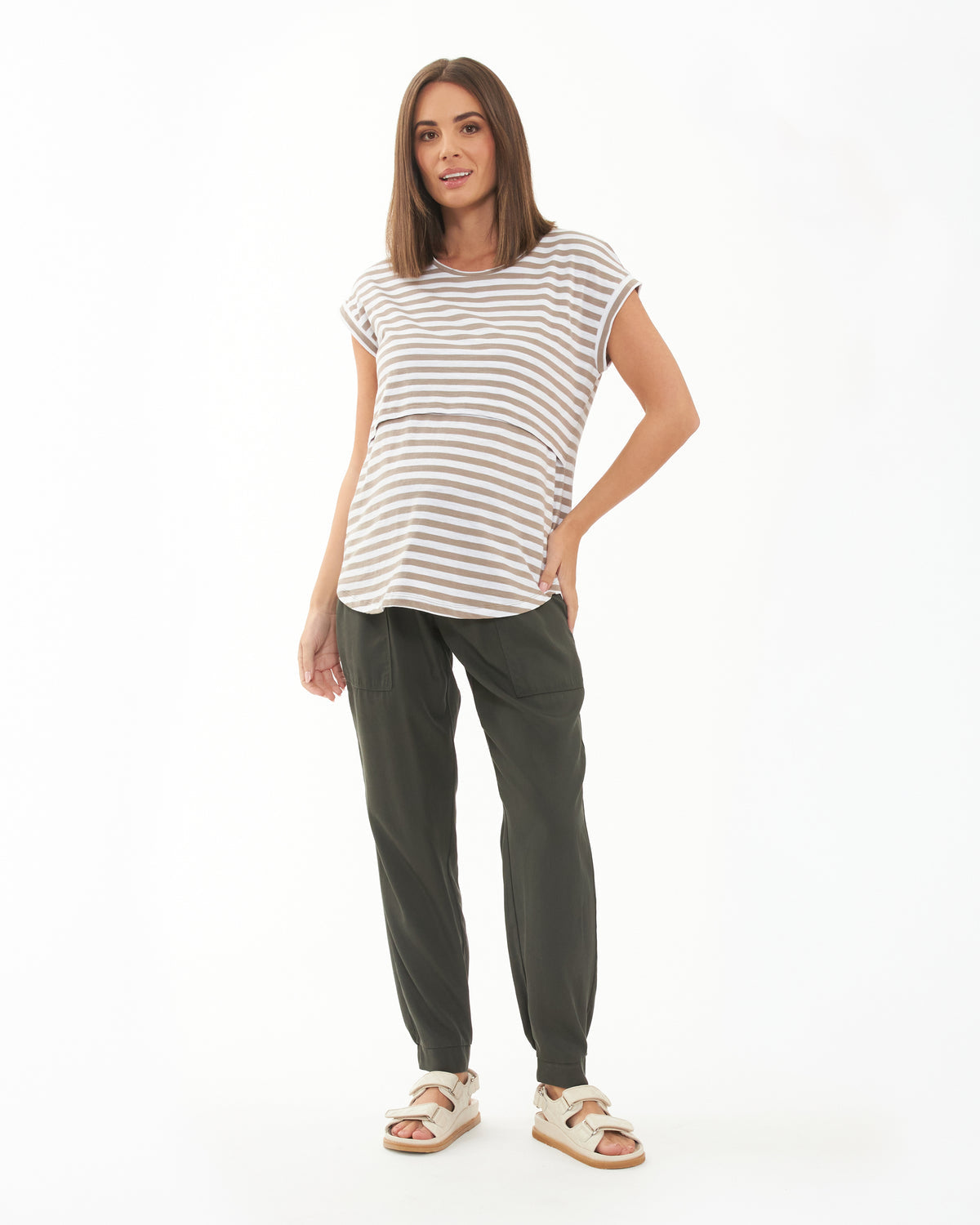 Pregnant Woman wearing a striped shirt and green pants on a white background
