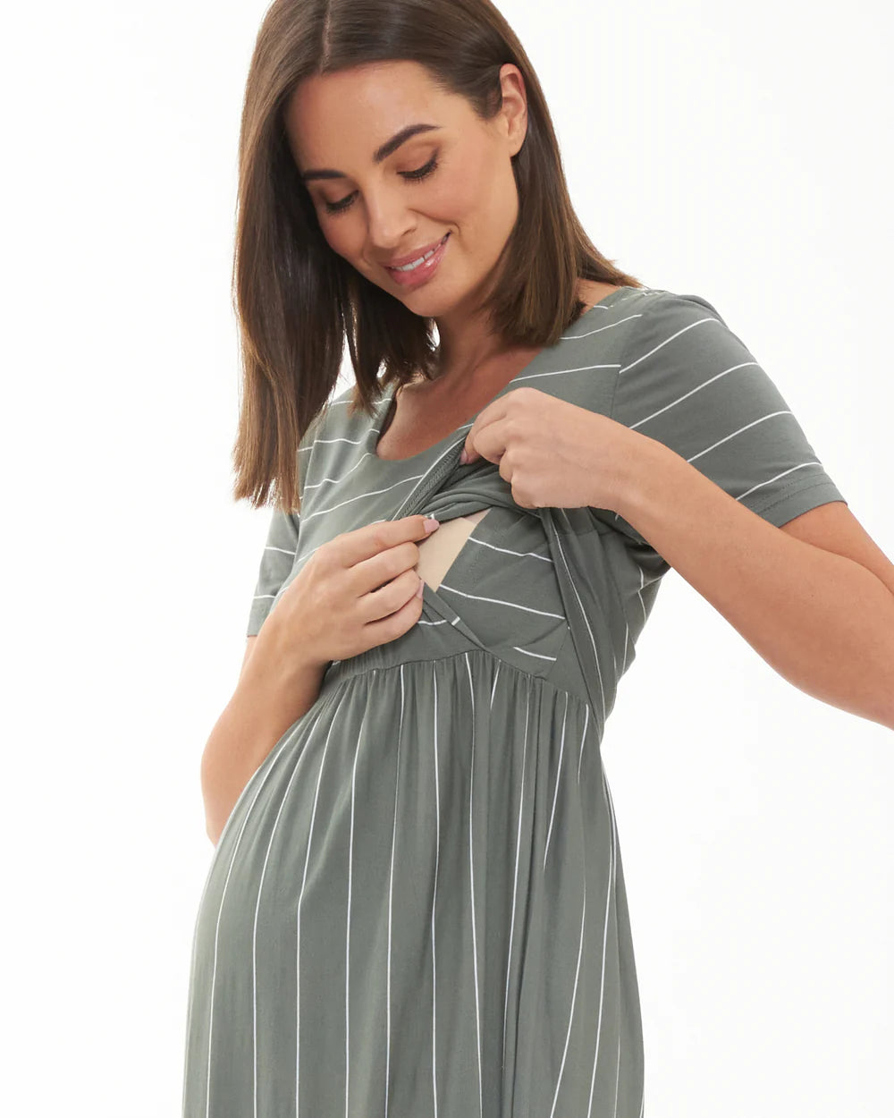 Pregnant Woman wearing a green and white striped maternity dress on a white background