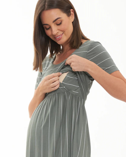 Pregnant Woman wearing a green and white striped maternity dress on a white background