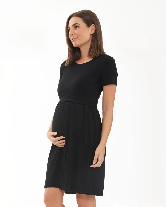 Pregnant Woman wearing a black maternity dress on a white background