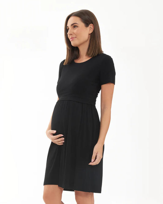 Pregnant Woman wearing a black maternity dress on a white background