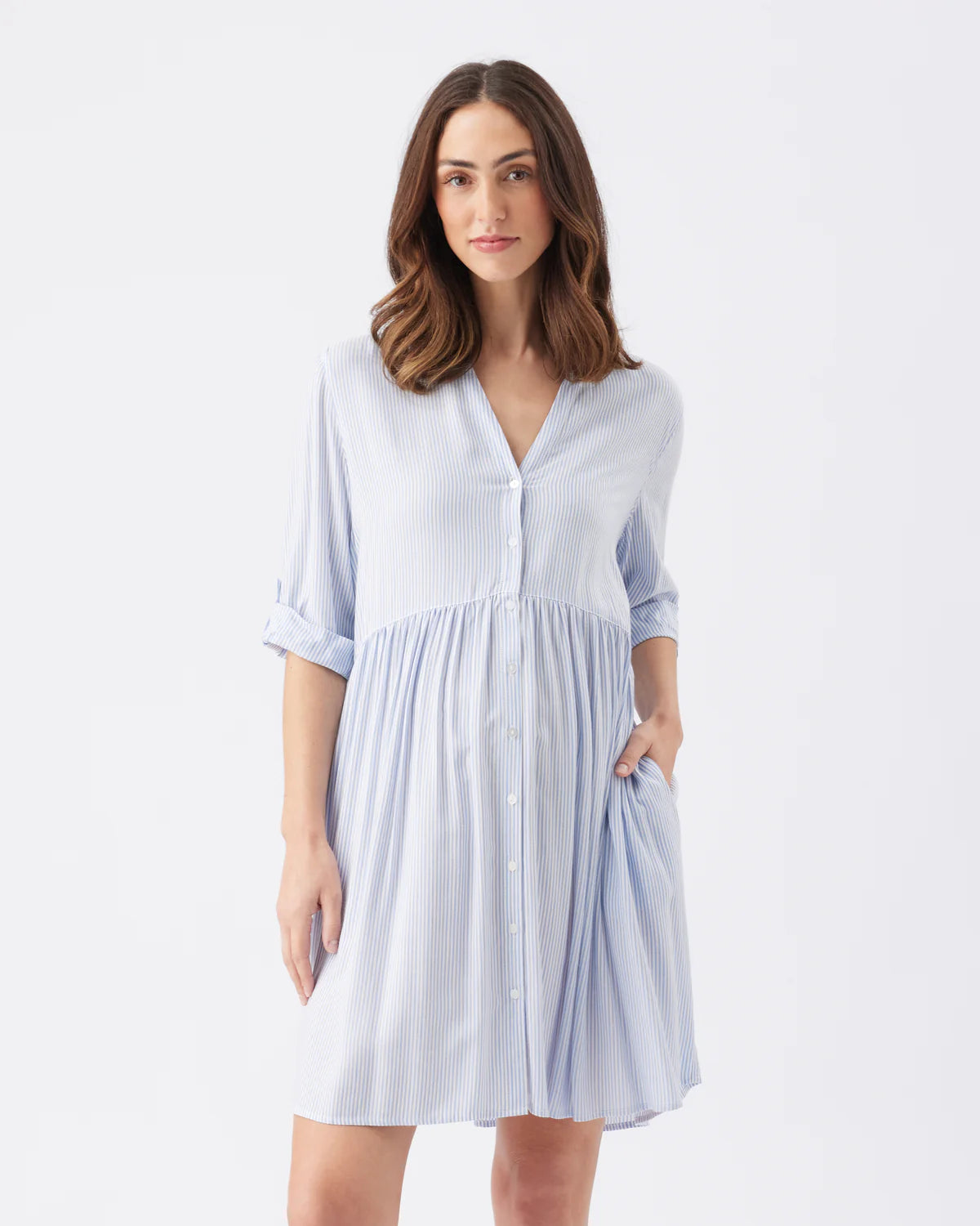 Pregnant Woman wearing a light blue maternity dress on a white background