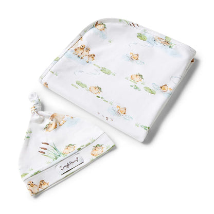 Baby blanket and hat set with animal pattern on a white background