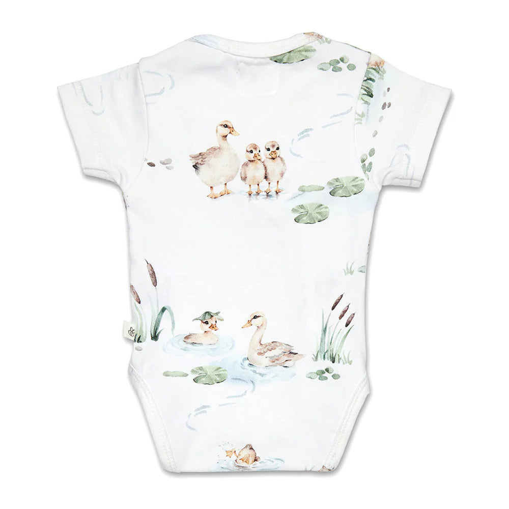 Baby onesie with duckling pattern on a white background