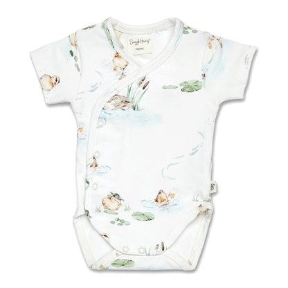 Baby onesie with nature-themed print on a white background