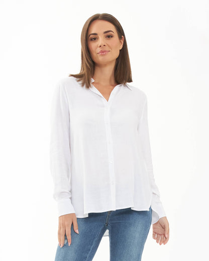 Pregnant Woman wearing a white shirt and blue jeans on a white background