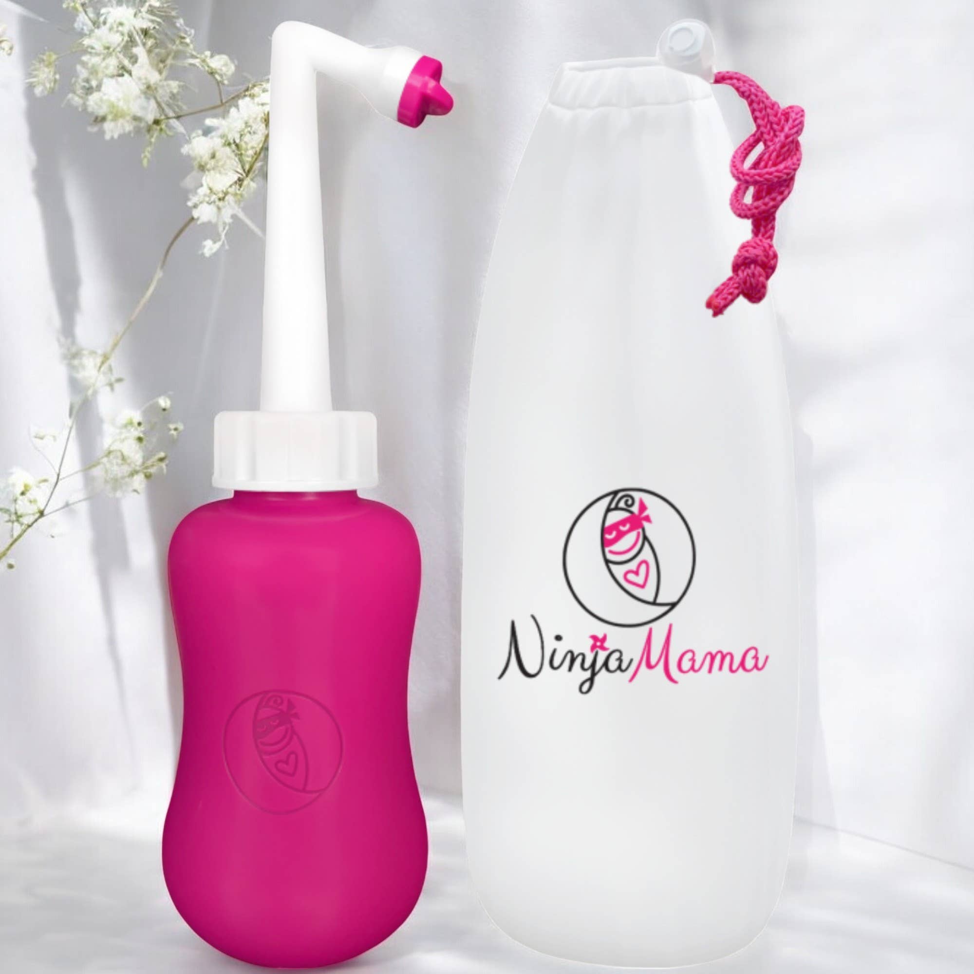 Pink postpartum perineal bottle with white nozzle and pink carrying strap on a white background with 'Ninja Mama' logo.