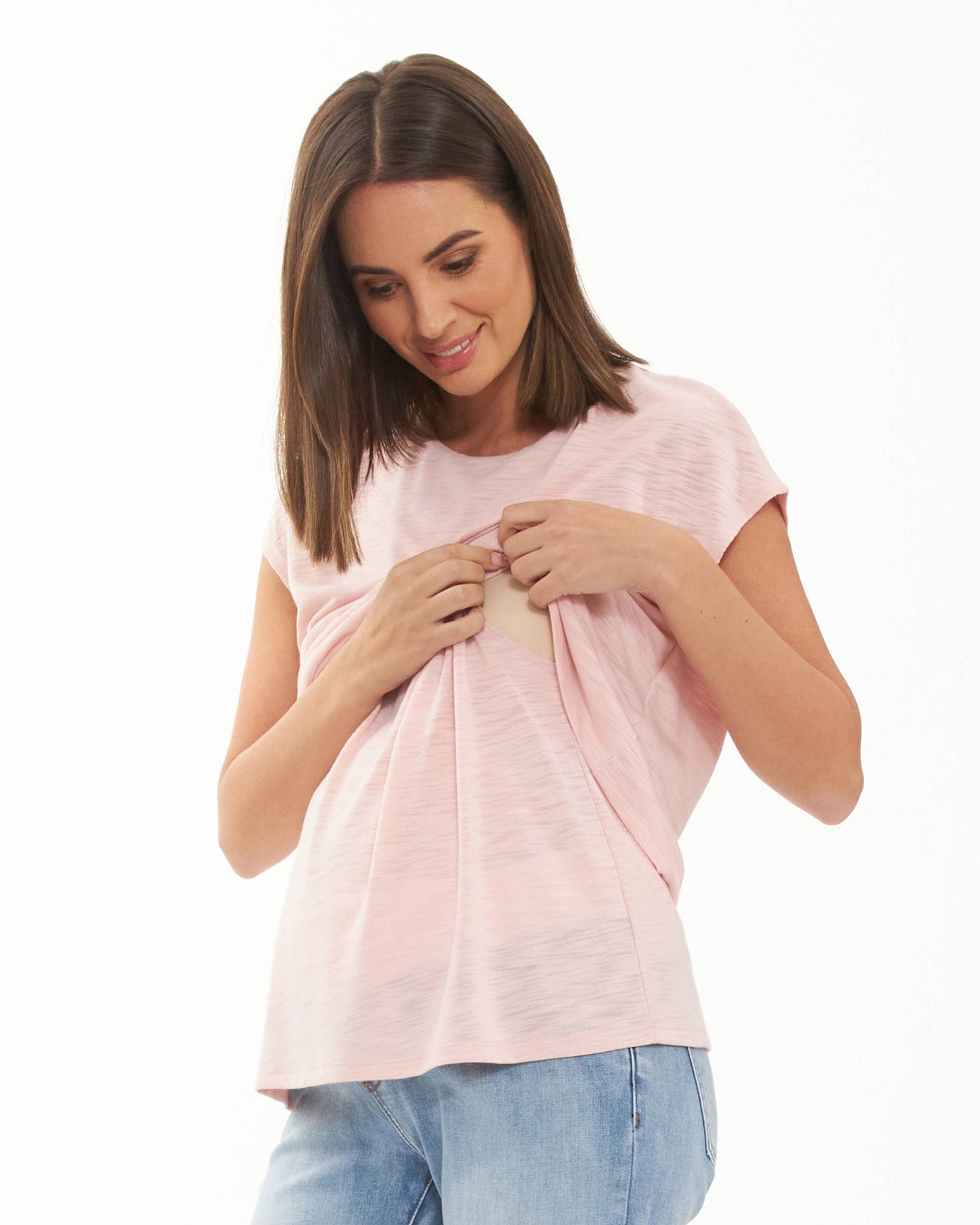 Pregnant Woman wearing a pink t-shirt and blue jeans on a white background