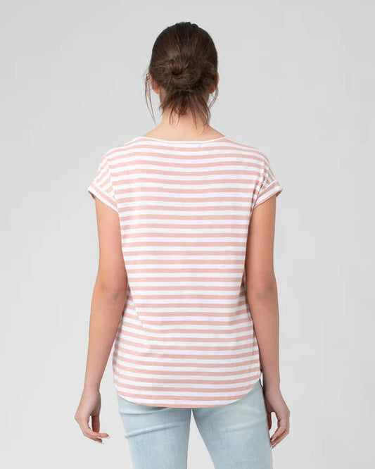 Pregnant Person wearing a pink and white striped t-shirt on a plain background