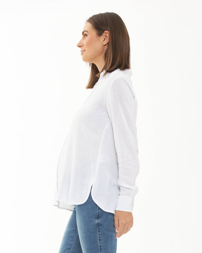 Pregnant Woman wearing a white shirt and blue jeans on a white background