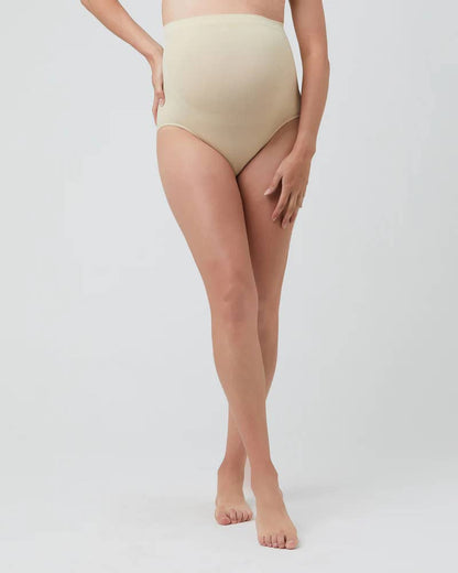 Person wearing beige high-waisted bikini bottoms on a white background