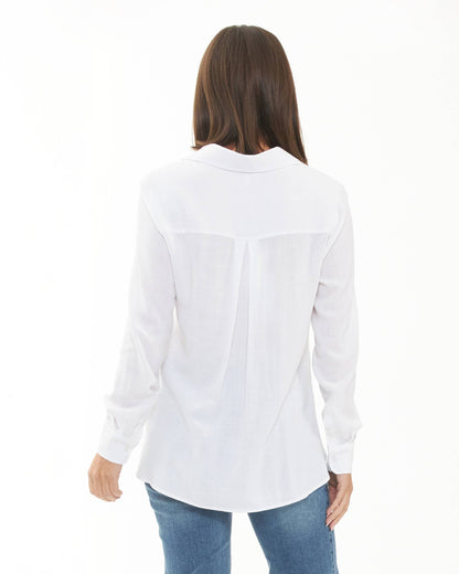 Pregnant Woman wearing a white shirt and blue jeans on a white background